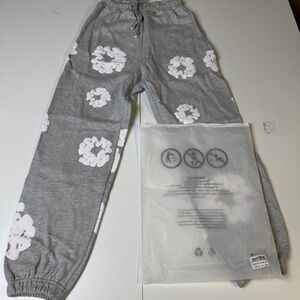 Denim Tears Pants with White Floral Design